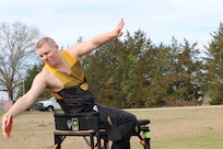 U.S. Army veteran Spc. Gerald Blakley reaches way back before throwing the discus  during the field event at the Army Trials, Fort Liberty, North Carolina