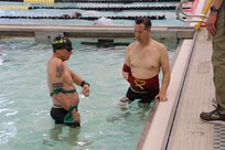 U.S. Army veteran Sgt. 1st Class Douglass Duval, left, Maj. Jeremy Ditlevson, have a short discussion before the swimming event at the Army Trials, Fort Liberty, North Carolina