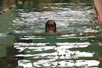 U.S. Army 1st Lt. Hannah Wright breaks the surface executing the breaststroke during the swimming event at the Army Trials, Fort Liberty, North Carolina