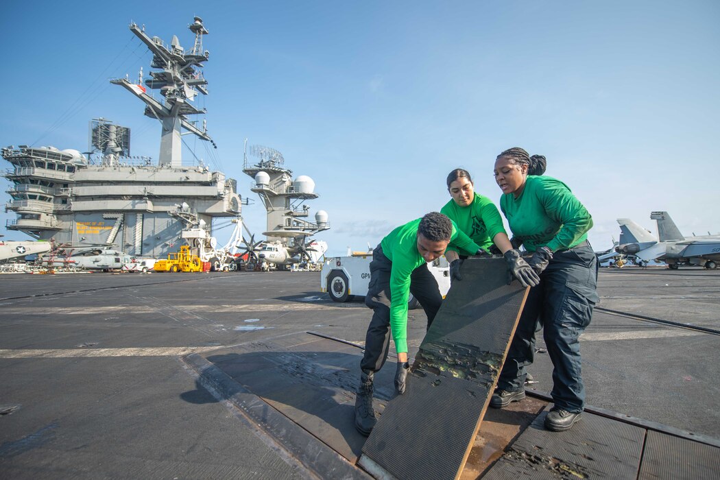 Sailors maintain arresting gear aboard USS Theodore Roosevelt (CVN 71) in the Philippine Sea.