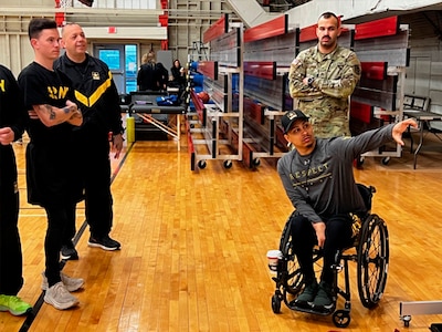 Coach Joel Rodriguez is going over plays with Soldier athletes at the 2024 Wheelchair Rugby Camp.