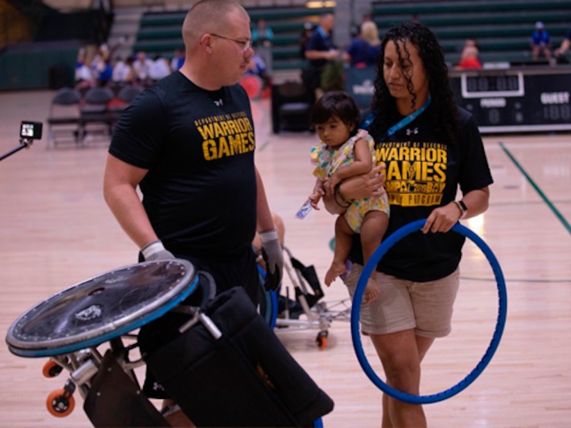 Wheelchair mechanic Liannie Rodriguez is out on the floor fixing a wheelchair during Team Army’s wheelchair rugby practice at the 2022 Warrior Games in Orlando.