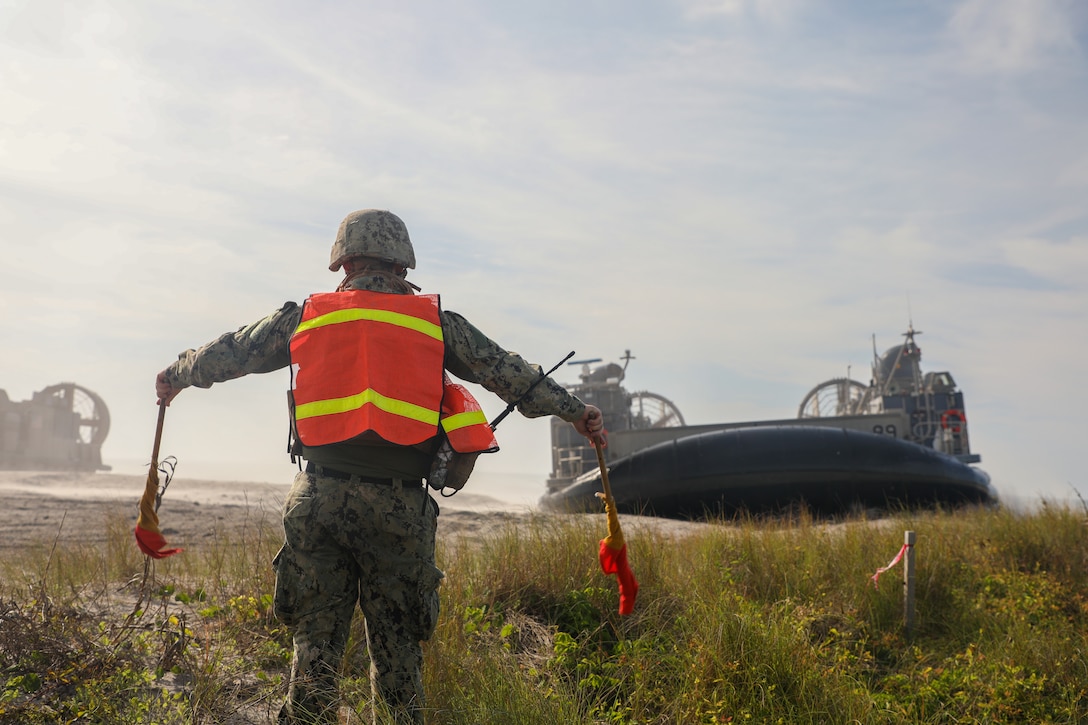 U.S. Marines and Sailors with the Wasp (WSP) Amphibious Ready Group (ARG) and 24th Marine Expeditionary Unit (MEU) come ashore via a landing craft air cushion from the USS New York (LPD 21) to conduct a non-combatant evacuation exercise during Composite Unit Training Exercise (COMPTUEX) at Onslow Beach, Camp Lejeune, North Carolina, April 17, 2024. The WSP ARG-24th MEU is conducting COMPTUEX, their final at-sea, certification exercise under the evaluation of Carrier Strike Group 4 and Expeditionary Operations Training Group. Throughout COMPTUEX, the WSP ARG-24th MEU will be evaluated across a spectrum of scenarios that determine their readiness to deploy. (U.S. Marine Corps Photo by Cpl. Victoria Hutt)