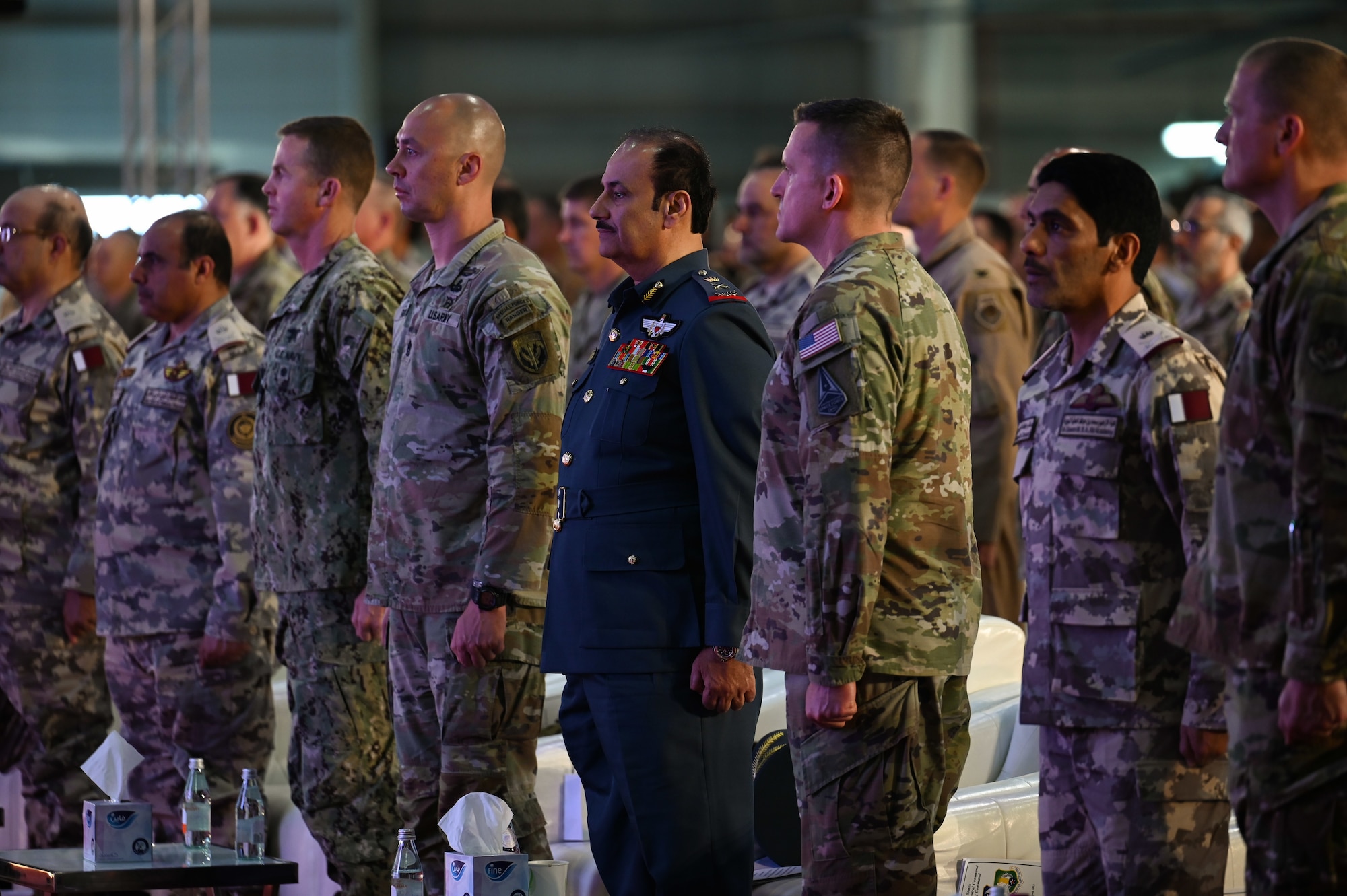 U.S. and coalition partners stand at attention during Lt. Gen. Derek France's change of command ceremony at Al Udeid Air Base, Qatar, April 18, 2024. Hundreds of Airmen, joint and coalition partners, and senior regional military officials attended the ceremony, highlighting the U.S.’s focus on building and maintaining critical partnerships through a collective vision for peace and security throughout the region. (U.S. Air Force photo)