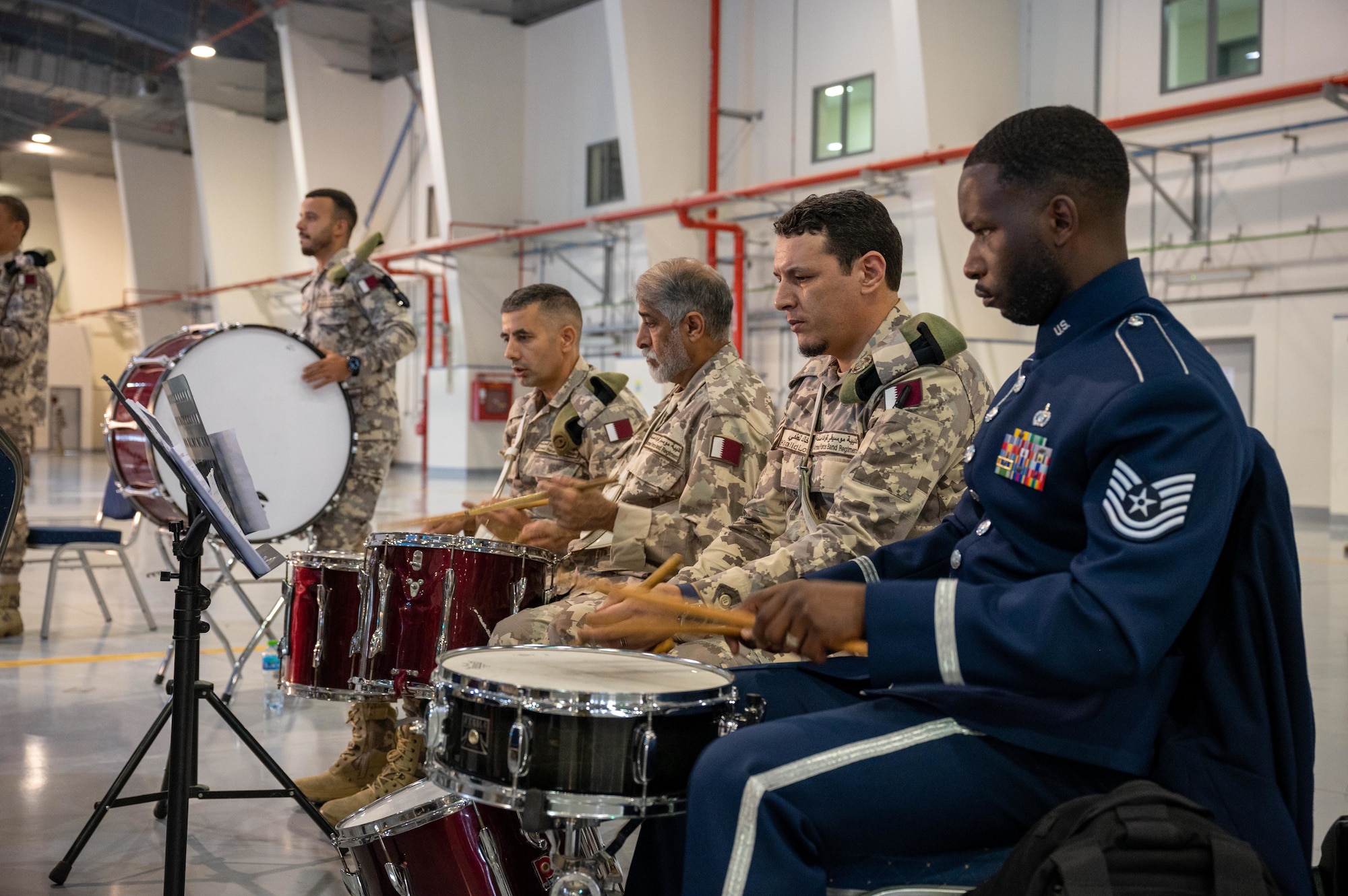 Qatari Emiri Air Force and United States Air Force Central band members perform a musical piece on percussion instruments during Lt. Gen. Derek France's change of command ceremony at Al Udeid Air Base, Qatar, April 18, 2024. AFCENT, in concert with coalition, joint, and interagency partners, delivers decisive air, space and cyberspace capabilities for CENTCOM, allied nations and the U.S. (U.S. Air Force photo)