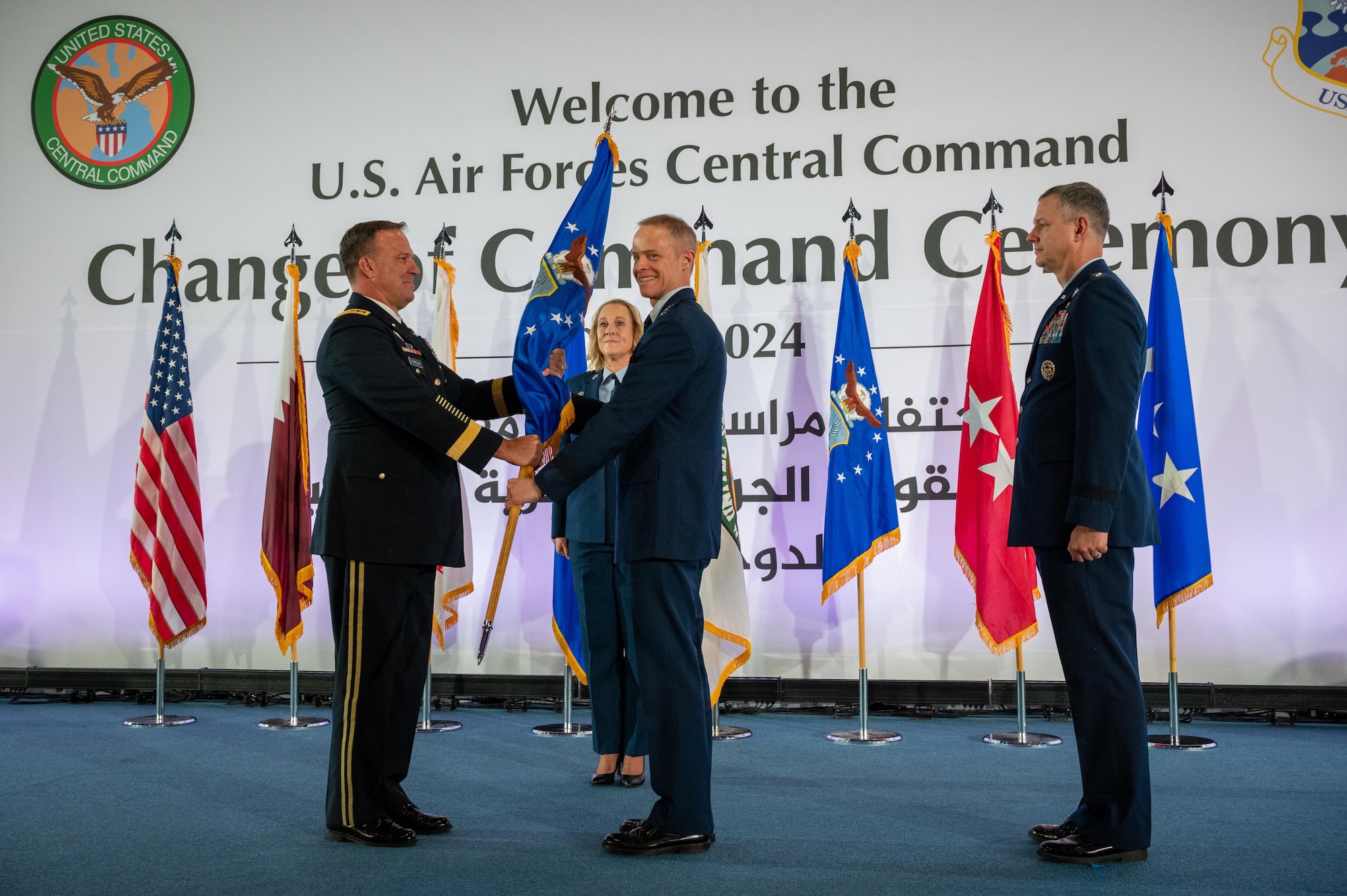 U.S. Army Gen. Michael E. Kurilla (left), U.S. Central Command commander, passes the ceremonial guidon to U.S. Air Force Lt. Gen. Derek France (center), commander of Ninth Air Force (Air Forces Central), during a change of command ceremony at Al Udeid Air Base, Qatar, April 18, 2024. France takes command of over 15,000 personnel across five air expeditionary wings working alongside regional and coalition partners to stabilize the CENTCOM area of responsibility. (U.S. Air Force photo)