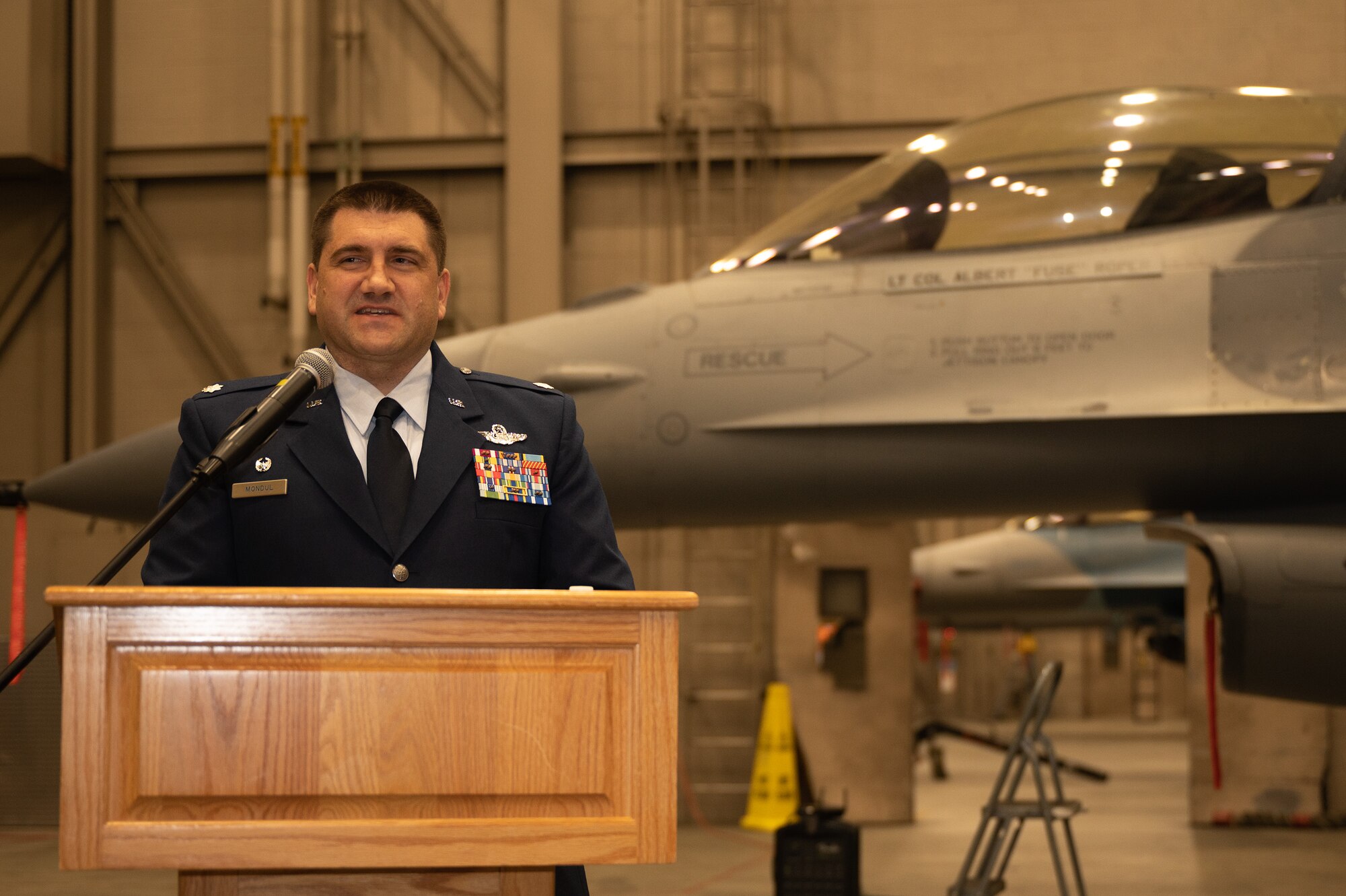 A squadron commander gives remarks during a change of command ceremony.