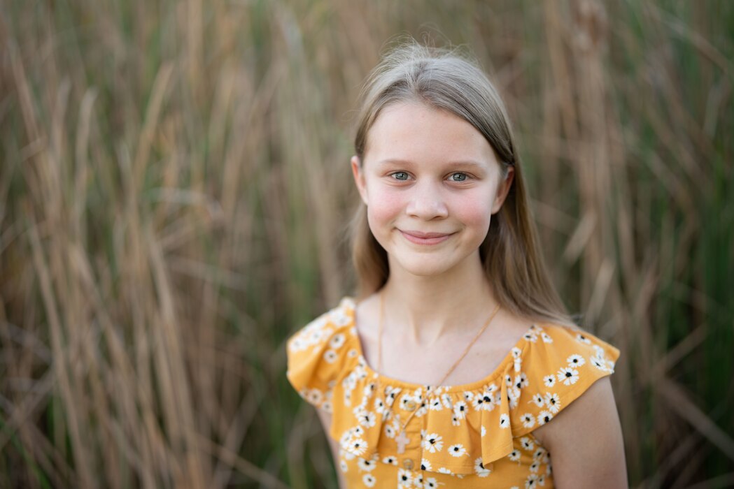 a military child smiles for a photo