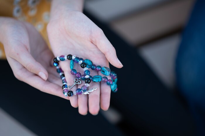 a child holding bracelets that she created
