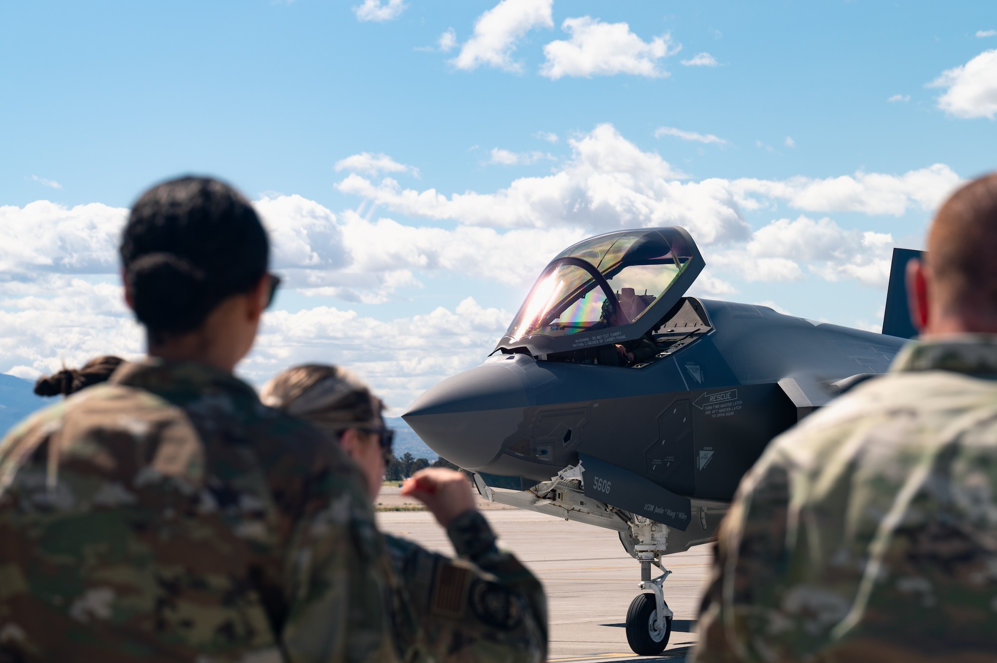 U.S. Air Force Airmen assigned to the 59th Test and Evaluation Squadron, Maintenance Operational Test (MxOT) division observe the arrival of F-35 Lightning IIs at Nellis Air Force Base, Nevada, April 1, 2024.