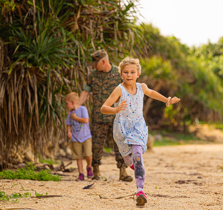 Fiona Blyleven runs ahead of her brother, Sam, and her father, Lt. Col. Scott Blyleven, an operational planner with the 3rd Marine Expeditionary Brigade, on Camp Courtney Beach, Okinawa, Japan, April 15, 2024. The Month of the Military Child, celebrated annually in April, recognizes military children for the daily sacrifices and challenges they overcome. (U.S. Marine Corps photo by 1st Lt. Samuel H. Barge)