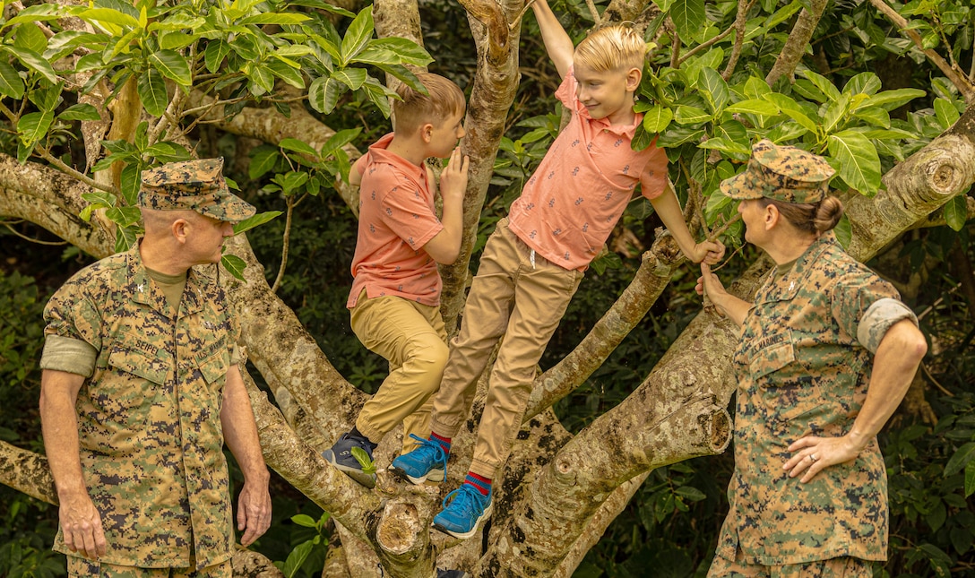 Col. Patrick Seipel and Col. Petra Seipel, both senior officers in charge of supply and logistics at the 3rd Marine Expeditionary Brigade and the 1st Marine Aircraft Wing, watch their sons, Harley and Max, climb a tree on Camp Courtney, Okinawa, Japan, April 13, 2024. The Month of the Military Child, celebrated annually in April, recognizes military children for the daily sacrifices and challenges they overcome. (U.S. Marine Corps photo by 1st Lt. Samuel H. Barge)