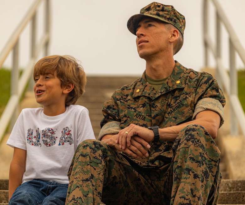 Maj. Marcos Azua, the comptroller for the 3rd Marine Expeditionary Brigade, poses with his son, Martin, on Camp Courtney, Okinawa, Japan, April 12, 2024. The Month of the Military Child, celebrated annually in April, recognizes military children for the daily sacrifices and challenges they overcome. (U.S. Marine Corps photo by 1st Lt. Samuel H. Barge)