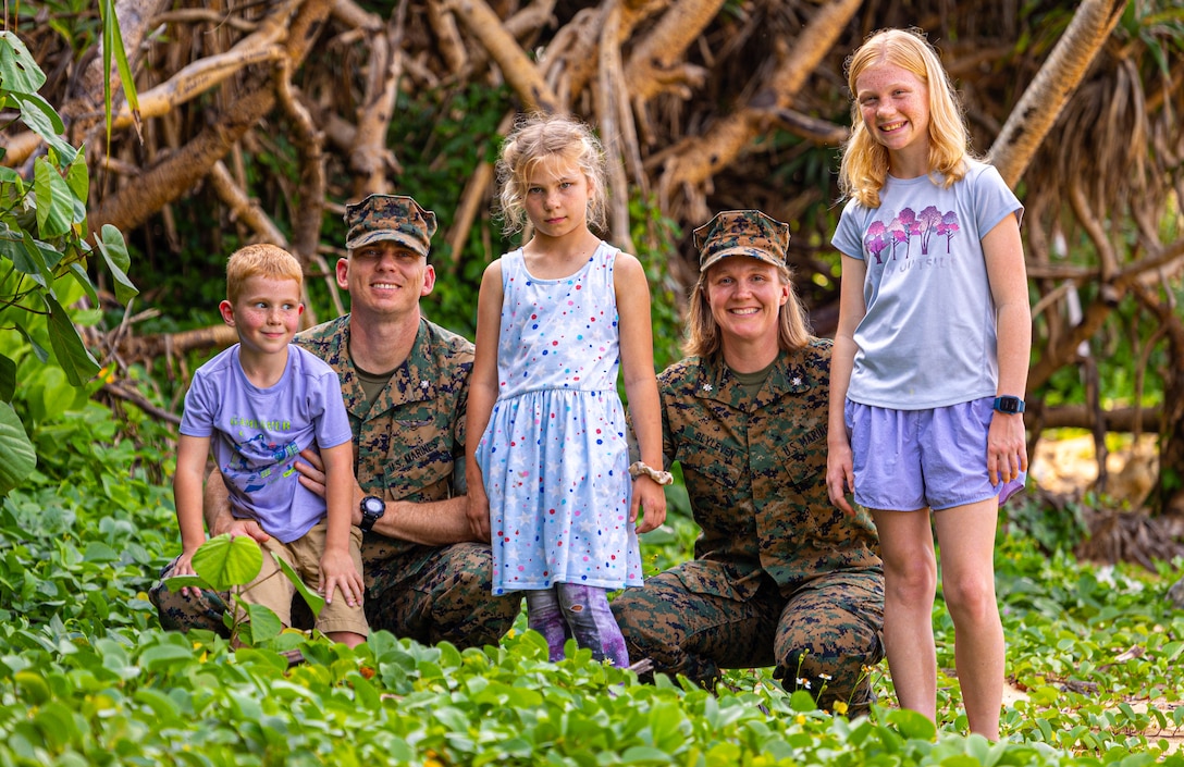 Lt. Col. Scott Blyleven, an operational planner with the 3rd Marine Expeditionary Brigade, and Lt. Col. Melissa Blyleven, a logistics planner with the III Marine Expeditionary Force, pose with their children, Sam, Fiona and Hanna, on Camp Courtney, Okinawa, Japan, April 15, 2024. The Month of the Military Child, celebrated annually in April, recognizes military children for the daily sacrifices and challenges they overcome. (U.S. Marine Corps photo by 1st Lt. Samuel H. Barge)
