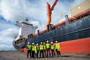 Pathfinders pose for a group photo outside of the MV Sagamore cargo ship