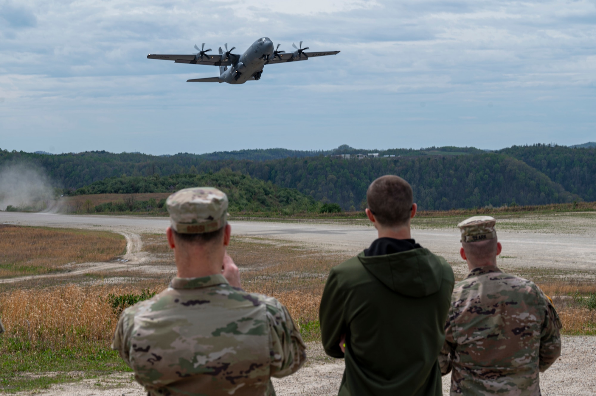 A U.S. Air Force C130J-30 takes off from an unpaved runway as Distinguished Visitors (DV) look on during Sentry Storm 24 DV Day, April 17, 2024, at Camp Branch, Logan County, W.Va. Sentry Storm is an exercise staged at McLaughlin ANGB in Charleston, Camp Branch in Logan County, Shepherd Field in Martinsburg and in the skies over West Virginia, involving an estimated 500 personnel from the state’s Air and Army National Guard, partnering National Guard units form Kentucky, North Carolina, and Michigan, as well as Civil Air Patrol units. (U.S. Air National Guard photo by 2nd Lt. De-Juan Haley)