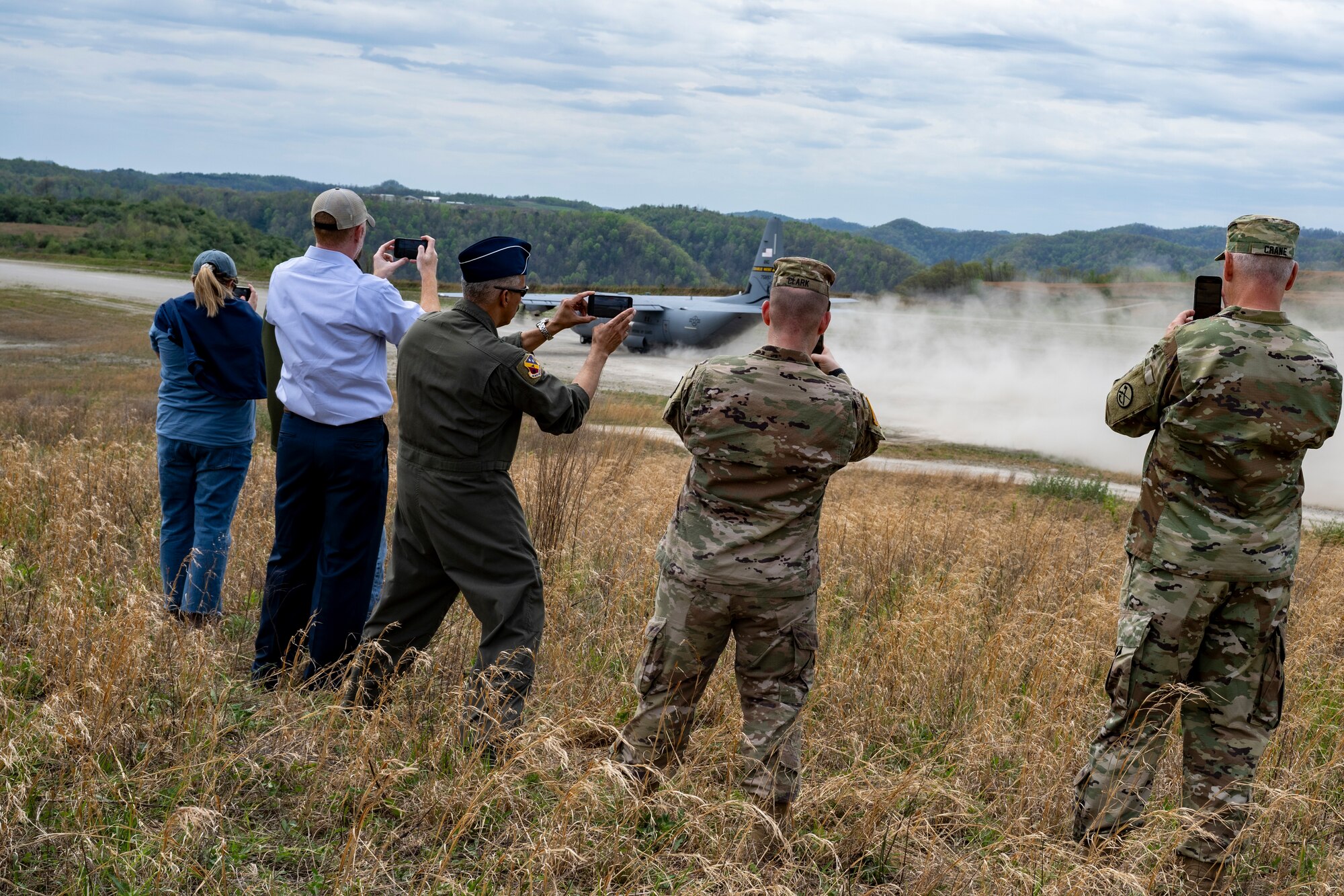 A U.S. Air Force C130J-30 takes off from an unpaved runway as Distinguished Visitors (DV) look on during Sentry Storm 24 DV Day, April 17, 2024, at Camp Branch, Logan County, W.Va. Sentry Storm is an exercise staged at McLaughlin ANGB in Charleston, Camp Branch in Logan County, Shepherd Field in Martinsburg and in the skies over West Virginia, involving an estimated 500 personnel from the state’s Air and Army National Guard, partnering National Guard units form Kentucky, North Carolina, and Michigan, as well as Civil Air Patrol units. (U.S. Air National Guard photo by 2nd Lt. De-Juan Haley)
