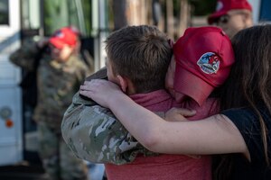 A U.S. Air Force Airman, assigned to the 823d Rapid Engineer Deployable Heavy Operational Repair Squadron Engineer, reunites with his family at Hurlburt Field, Florida, April 14, 2024. Airmen from the 823d RED HORSE spent six and a half months in Guam to rehabilitate and upgrade airfields on islands to support exercises and pre-positioning of assets throughout the pacific theater. (U.S. Air Force photo by Senior Airman Hussein Enaya)