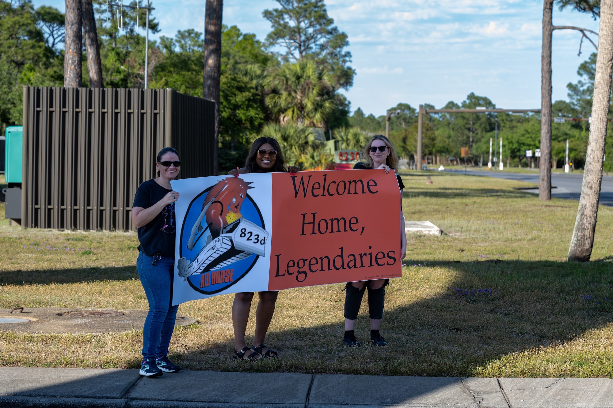 Families of the 823d Rapid Engineer Deployable Heavy Operational Repair Squadron Engineer Airmen hold a ‘Welcome Home Legendaries’ sign at Hurlburt Field, Florida, April 14, 2024. Airmen from the 823d RED HORSE spent six and a half months in Guam to restore and activate old runways in order to deter adversaries. (U.S. Air Force photo by Senior Airman Hussein Enaya)