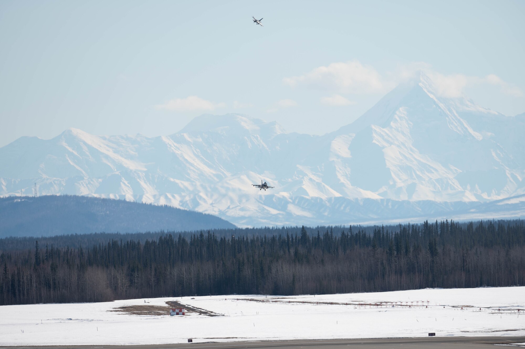 Two F-16 Fighting Falcon aircraft fly in for landing.