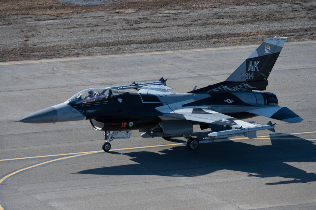 An F-16 Fighting Falcon taxies on the runway.