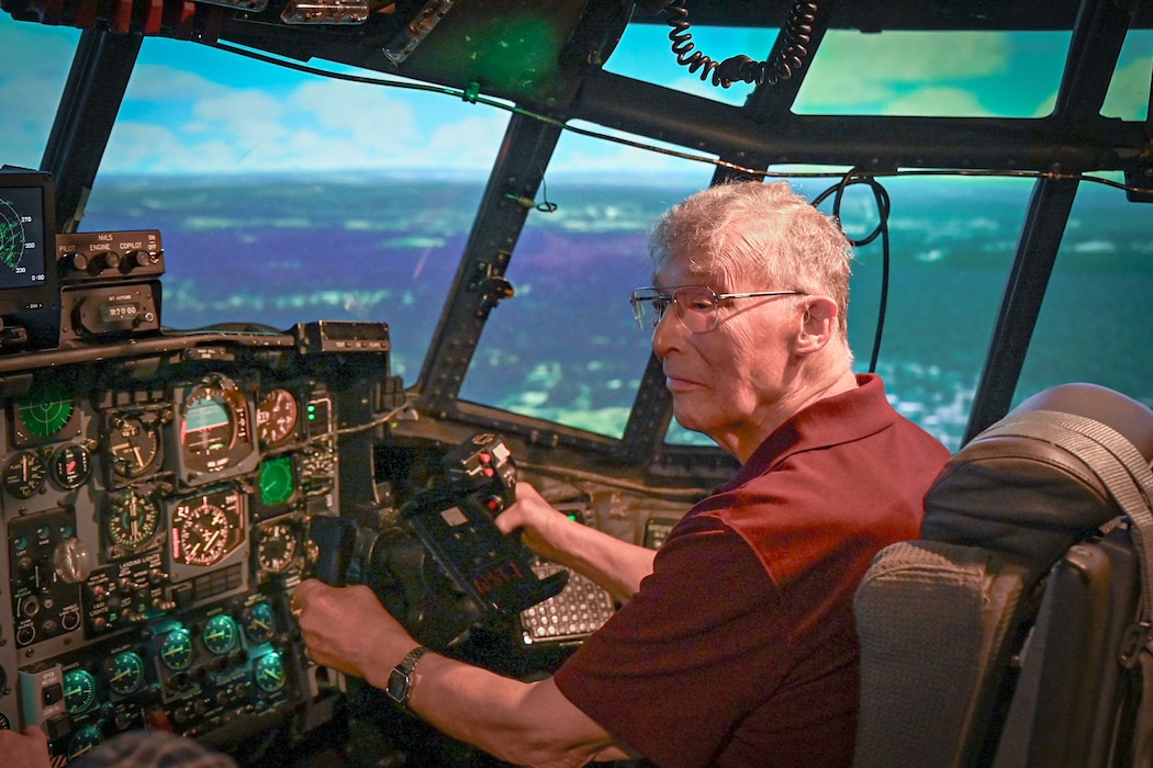 A person sits inside a flight simulator
