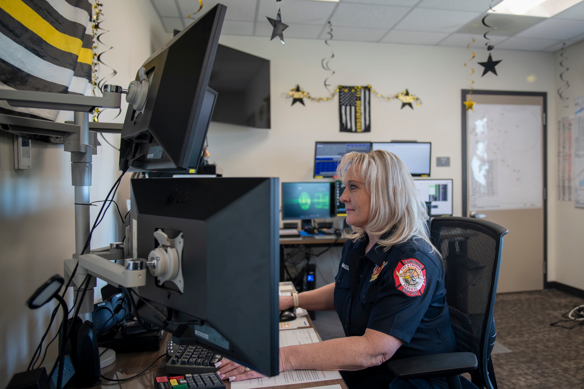 Darlene Magdaleno, emergency dispatcher, 812th Civil Engineer Squadron, operates an emergency dispatch station on Edwards Air Force Base, California, April 15. (Air Force photo by Giancarlo Casem)