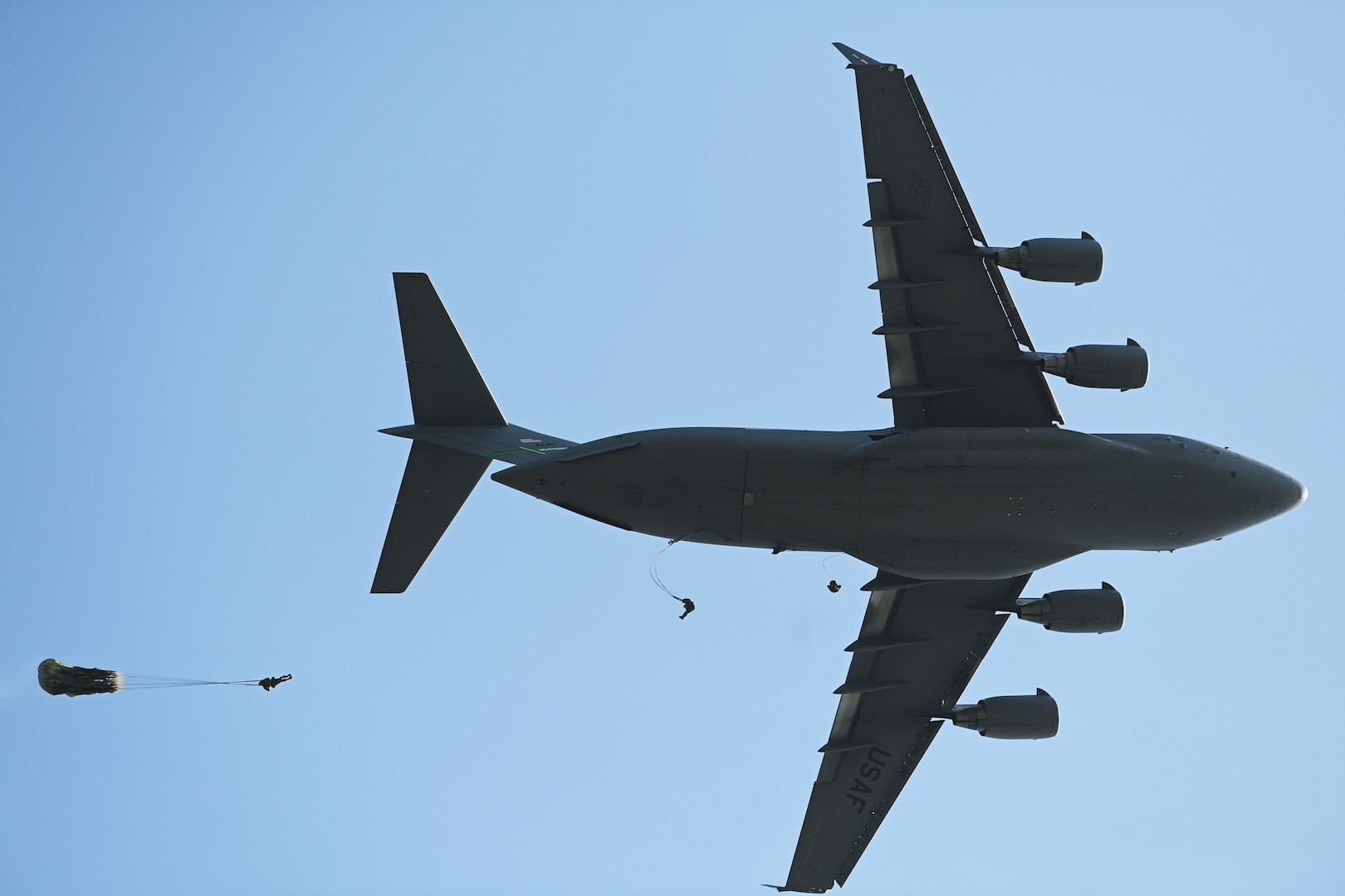 A U.S. C-17 from Joint Base Lewis McChord deploys special operations forces during a static-line parachute jump over Osan Air Base, Republic of Korea, April 18, 2024. Approximately 300 U.S. and Republic of Korea special operations forces personnel participated in a static-line Airborne training operation as part of Korea Flying Training 24, a combined ROK and U.S. exercise running April 12-26. (U.S. Air Force photo by Master Sgt. Eric Burks)