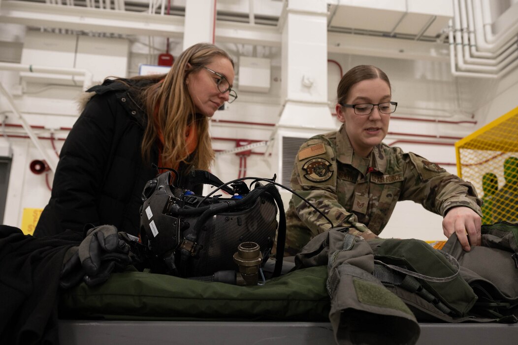 A demonstration of flight equipment by an Airman.
