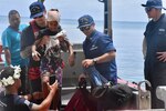 The crew of USCGC Oliver Henry (WPC 1140) arrive to Woleai, Yap State, Federated States of Micronesia, on April 12, 2024, with an injured 9-year-old boy and his parents for further transport aboard a Pacific Mission Aviation flight to a higher level of medical care in Yap. Upon arriving to Satawal to deliver drought relief supplies in partnership with USAID and the International Organization for Migration (IOM), the U.S. Coast Guard crew was informed of the boy's injury sustained when he fell from a tree. The ship's EMT, Petty Officer 1st Class Joshua Pablo, consulted a U.S. Coast Guard flight surgeon who recommended the medevac and provided care throughout the more than 13-hour overnight transit. This effort showcases the humanitarian spirit and readiness of the U.S. Coast Guard to respond to emergent health concerns. (U.S. Coast Guard photo)