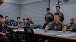 U.S. Air Force Col. Mike McCarthy, 8th Operations Group commander, leads a mission planning brief as part of Korea Flying Training 2024 at Kunsan Air Base, Republic of Korea, April 15, 2024. KFT 24 is an annual large-scale U.S. and ROKAF integration flying exercise designed to improve interoperability of combined and joint airpower execution, face-to-face combined mission planning, flying execution, and effective debriefing to train mission commanders and aircrew to operate and succeed in robust, complex scenarios. (U.S. Air Force photo by Staff Sgt. Jovan Banks)