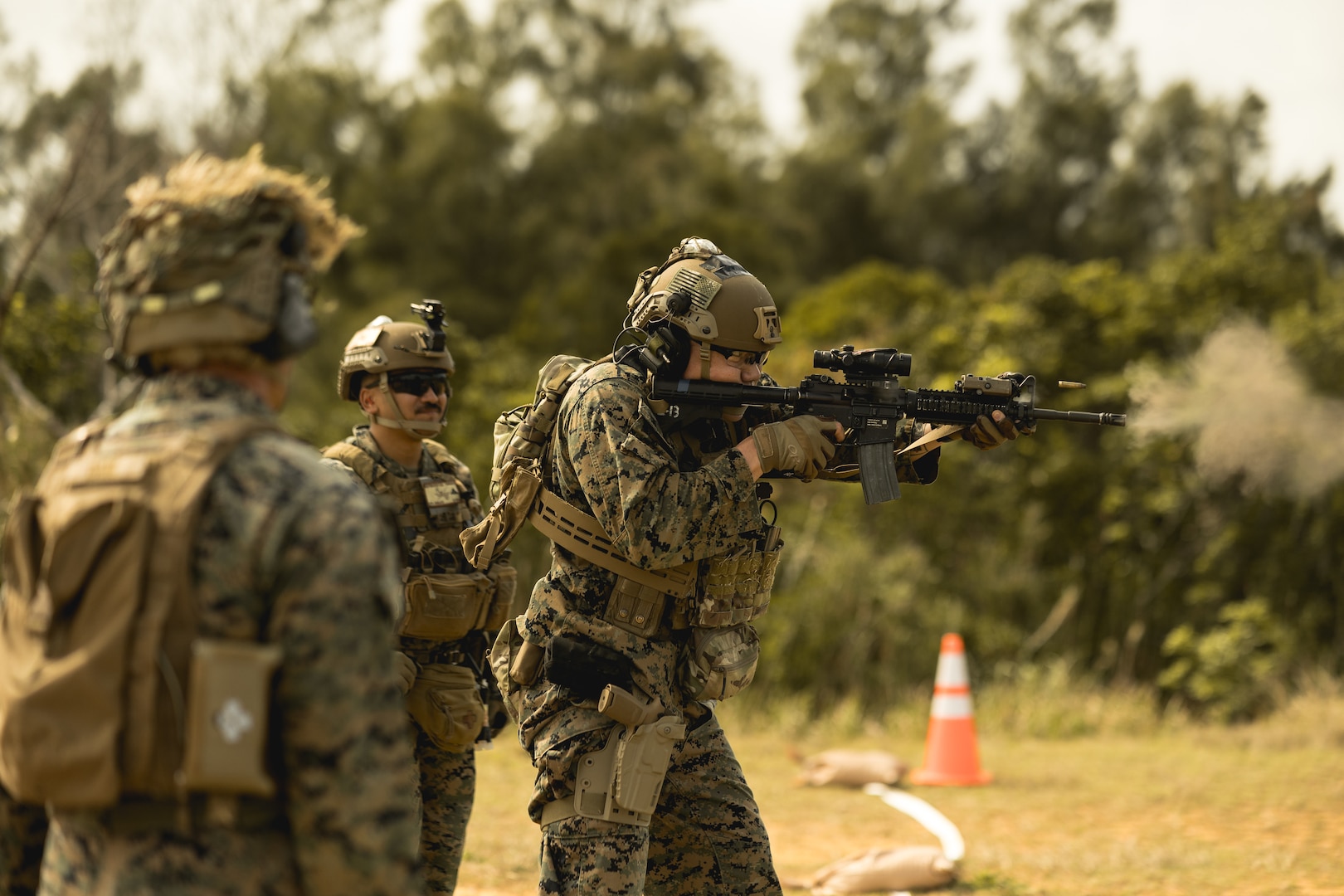 U.S. Marine Corps Staff Sgt. Sung Shin, right, a fires and effects integrator, with 5th Air Naval Gunfire Liaison Company, III Marine Expeditionary Force Information Group, fires a M4 carbine during a Marine Corps Combat Marksmanship Program range part of 2nd Brigades field exercise on Camp Hansen, Okinawa, Japan, Feb. 14, 2024. CMP allows Marines to maintain weapon proficiency by engaging targets in a competitive environment with primary and secondary weapon systems. 5th ANGLICO Marines refined their shooting fundamentals through advanced marksmanship training, enhancing their lethality. Shin is a native of Duluth, GA. (U.S. Marine Corps photo by Staff Sgt. Manuel A. Serrano)