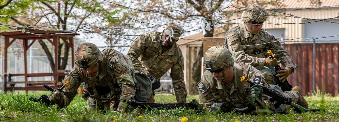 240417-A-LX531-1061 SOUTH KOREA (April 16, 2024) U.S. Army Soldiers assigned to Eighth Army and 3rd Cavalry Regiment, maneuver a litter through a wired obstacle during the Expert Field Medical Badge (EFMB) training at Camp Casey, South Korea, on April 16, 2024. The Department of the Army approved the Expert Field Medical Badge as a special skill award for recognition of exceptional competence and outstanding performance by field medical personnel, on 18 June 1965. (U.S. Army Reserve photo by Sgt. Jorge Reyes Mariano)