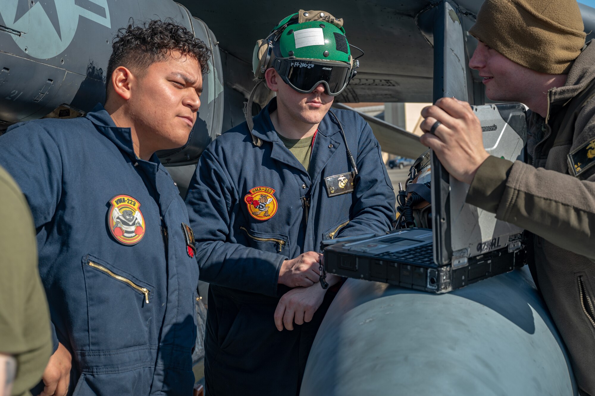Two plane captains read a technical order during an exercise.
