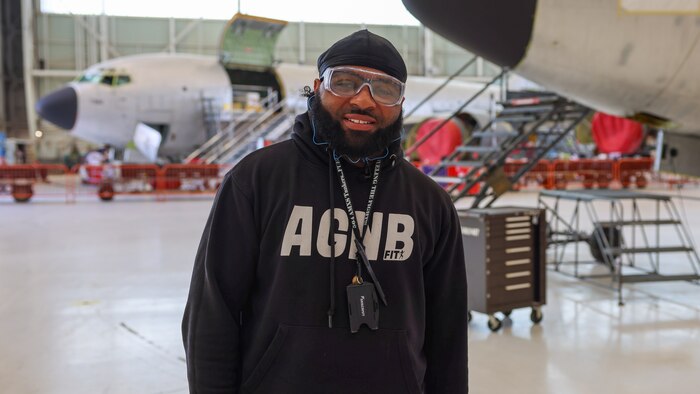Man standing in front of two aircraft