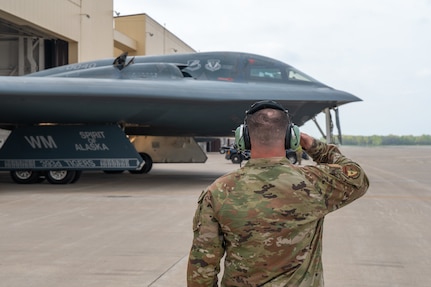 U.S. Air Force Senior Airman Joseph Santos, a crew chief assigned to the 509th Aircraft Maintenance Squadron, salutes B-2 Spirit stealth bomber pilots before takeoff during Exercise Spirit Vigilance, April 15, 2024, at Whiteman Air Force Base (AFB), Missouri. Spirit Vigilance is a base wide exercise Whiteman AFB performs in order to display nuclear deterrence and global strike operations anytime, anywhere. (U.S. Air National Guard photo by Airman 1st Class Grace Bynum)