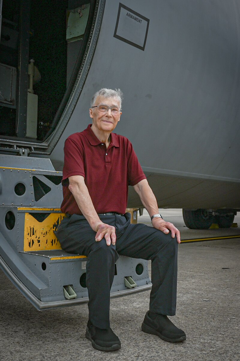 A person sits in front of an aircraft