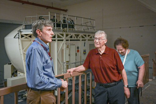 A family explores a flight simulator