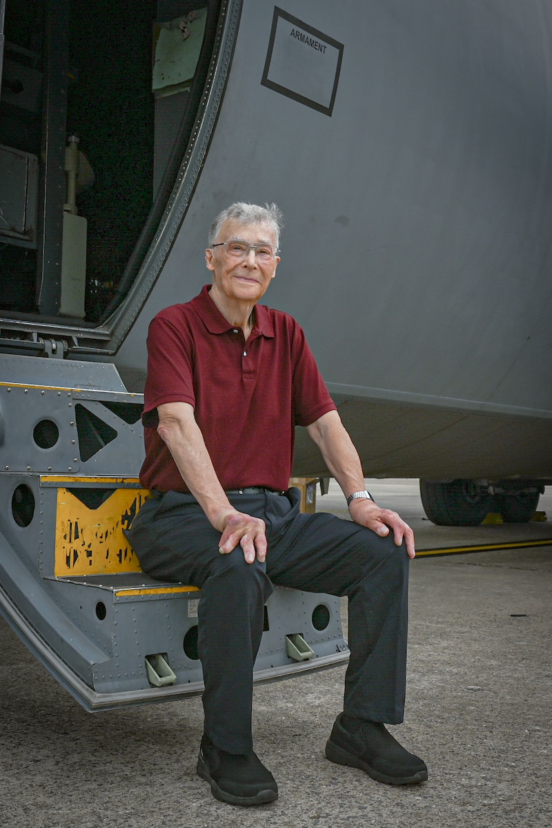 A person sits in front of an aircraft