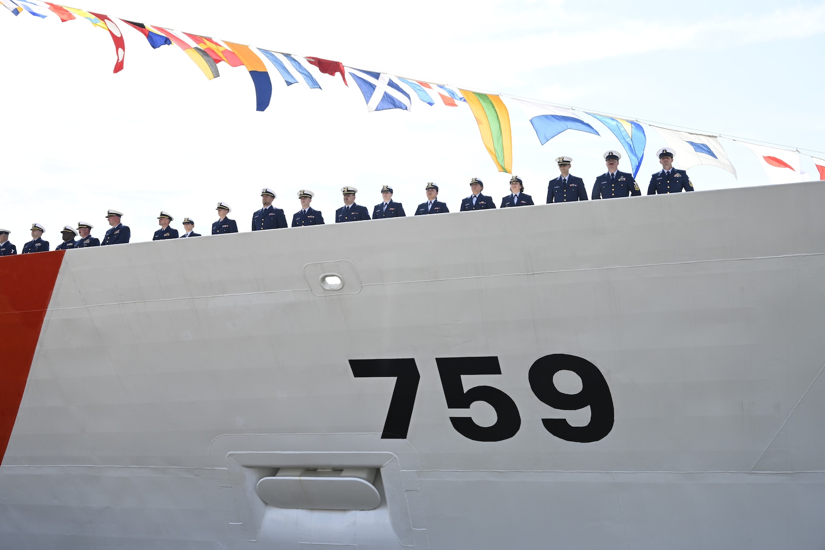 The crew of the Coast Guard Cutter Calhoun (WMSL 759) stands aboard the ship following its commissioning ceremony in North Charleston, South Carolina, April 20, 2024. The Calhoun, which is named for the first Master Chief Petty Officer of the Coast Guard, Charles Calhoun, was commissioned into service as the 10th National Security Cutter. (U.S. Coast Guard photo by Senior Chief Petty Officer Nick Ameen)