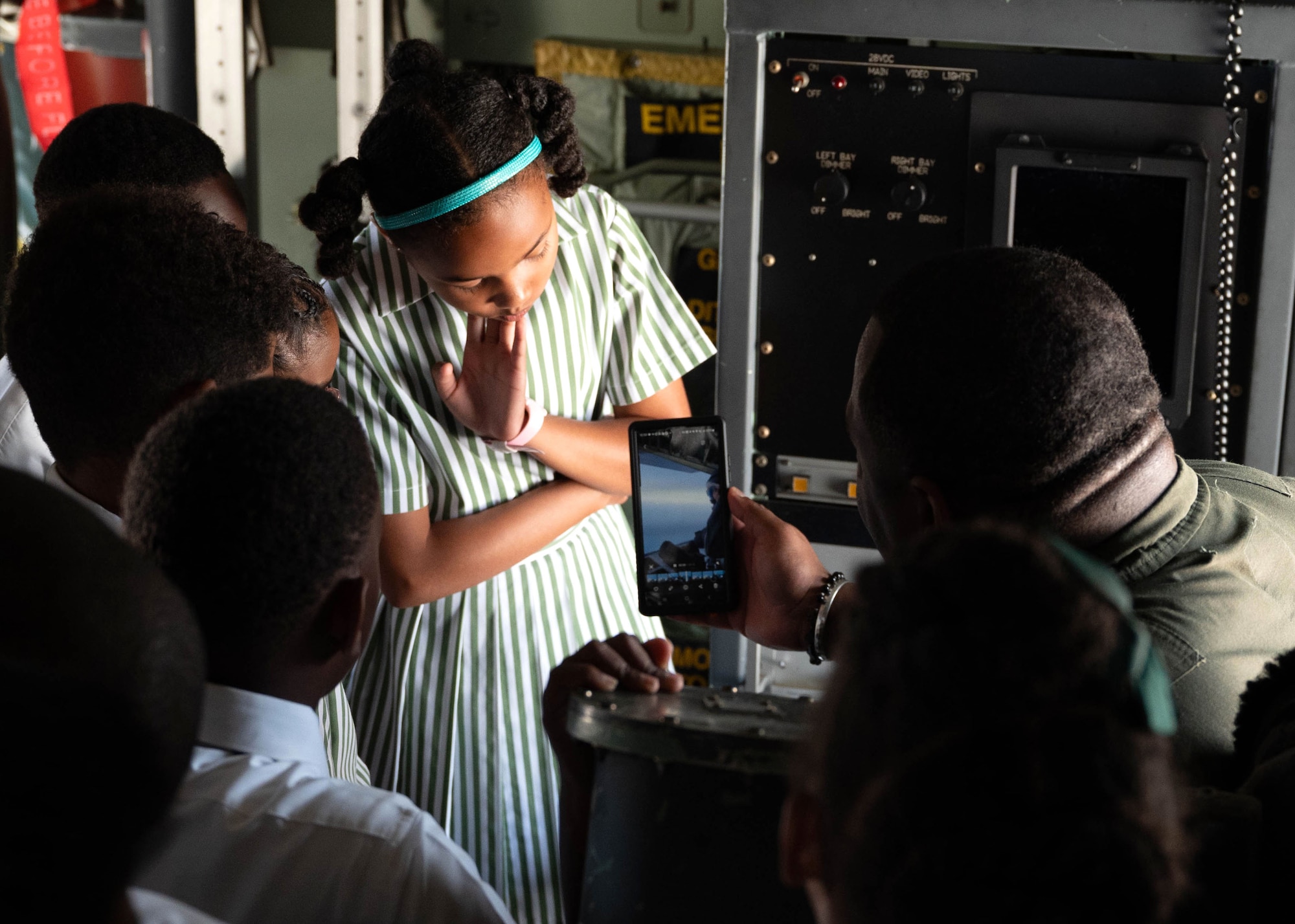 Airman showing students video on his phone