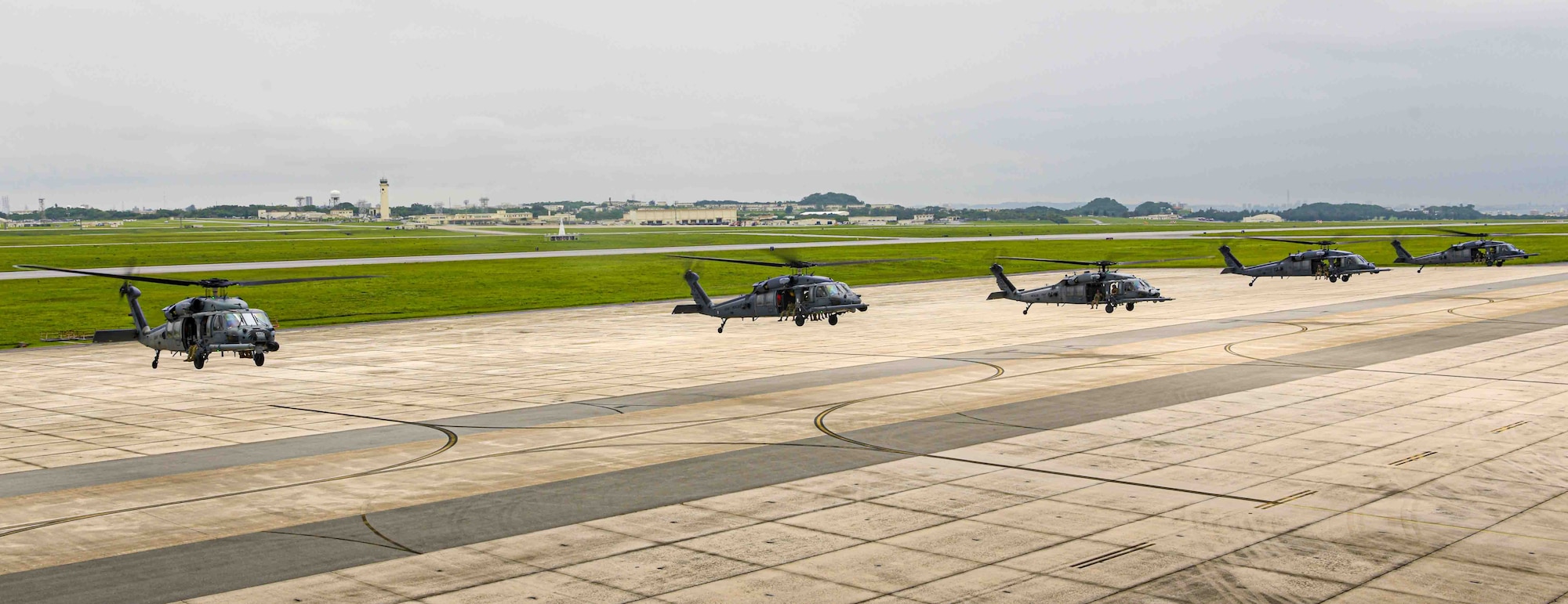 U.S. Air Force HH-60G Pave Hawks assigned to the 33rd Rescue Squadron hover in formation at Kadena Air Base, Japan, April 16, 2024.