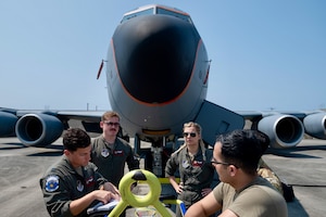 Airmen inspect aircraft maintenance logs