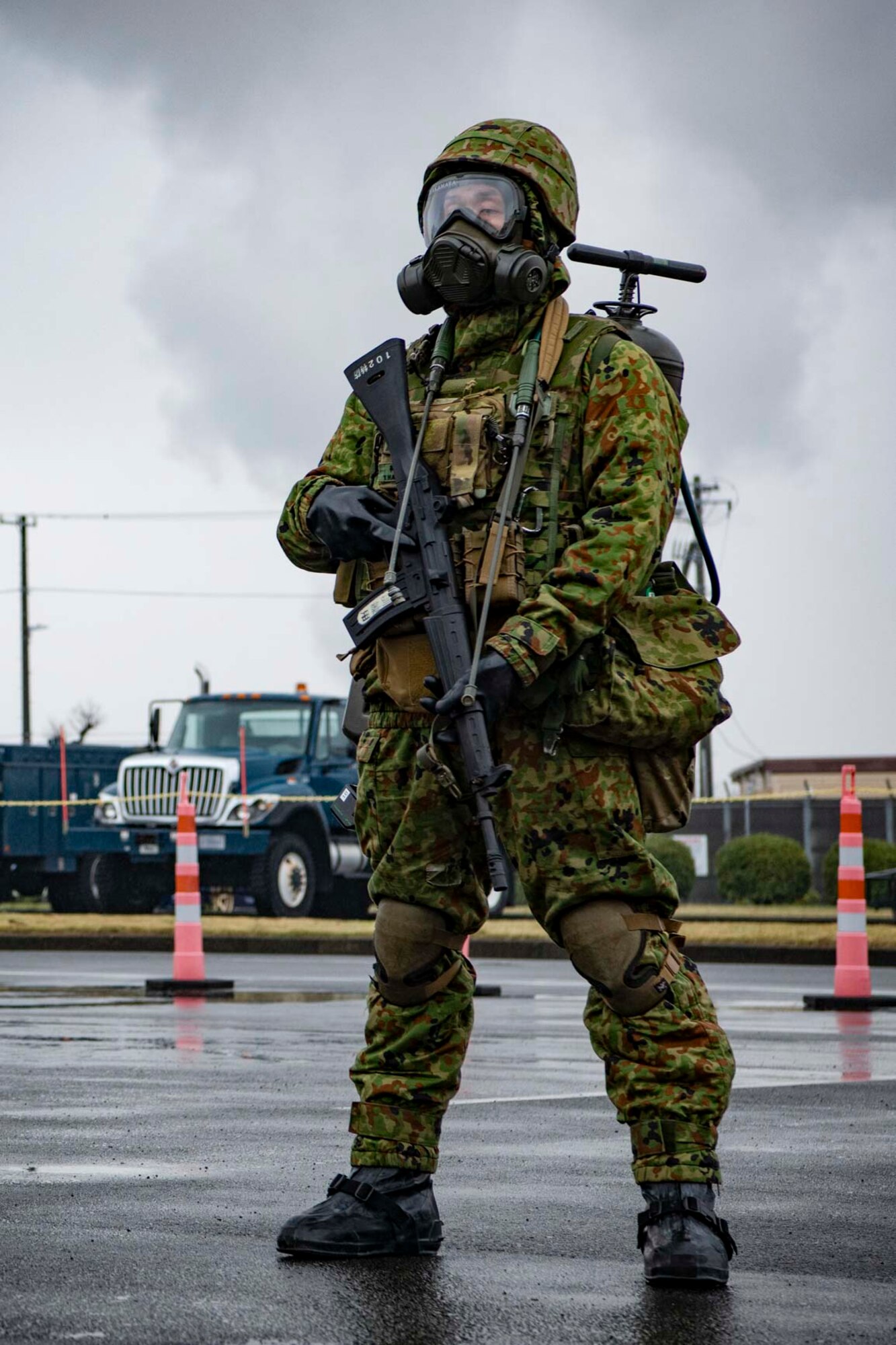 A Japanese military member holds a weapon.