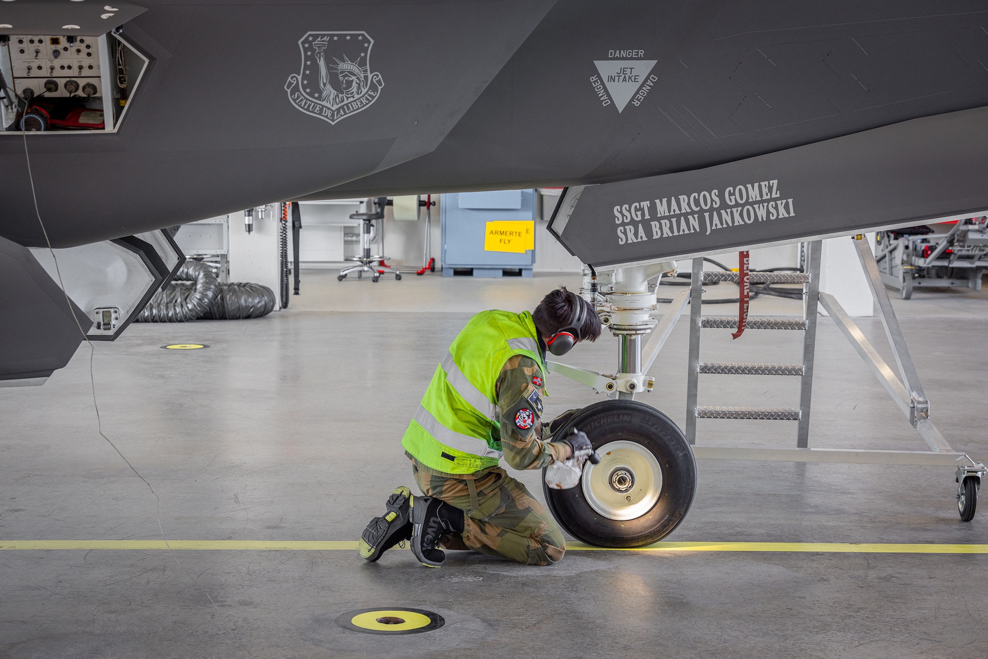 An Airman with the Royal Norwegian Air Force conducts maintenance on a U.S. F-35 Lightning II at Ørland Air Station in Norway, April 8, 2024. The mission marked the first time that Airmen from one nation’s military provided servicing to another nation’s F-35 aircraft without supervision. The cross servicing of aircraft between NATO partners highlights the future interoperability with fellow F-35 users across the European Theater. (RNoAF photo by Ole Andreas Vekve)