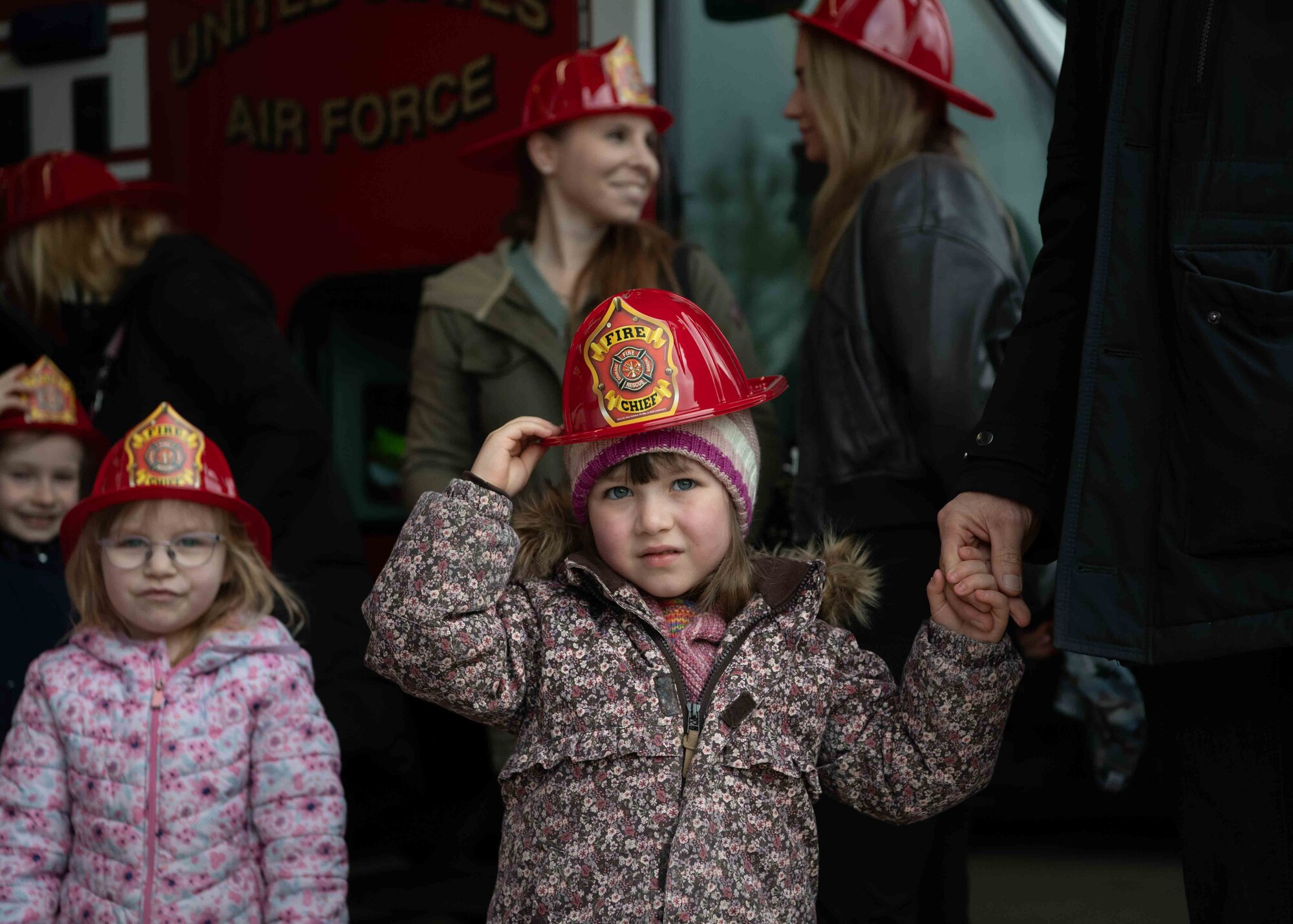 A Villa Winzig student holds her firefighter hat during a Villa Winzig at Ramstein Air Base, Germany, April 18, 2024. The 86th Airlift Wing Host Nation Office hosts the outreach program on a monthly basis, which bolsters the connection between Ramstein AB and the local community. Any active duty service member, civilians and dependents from Ramstein are able to volunteer. (U.S. Air Force photo by Airman Dylan Myers)