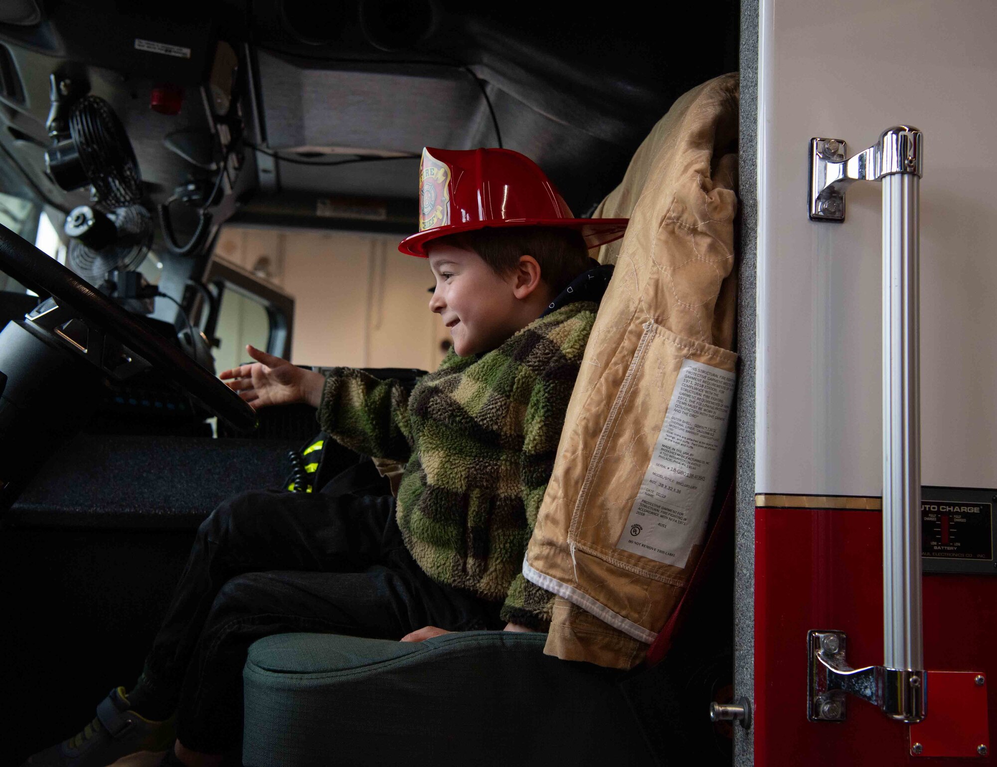 A Villa Winzig student sits in the driver's seat of a fire truck during a tour at Ramstein Air Base, Germany, April. 18, 2024. The Villa Winzig tour allowed Airmen to interact with local community children, promoting positive U.S. and German relations. (U.S. Air Force photo by Airman Dylan Myers)