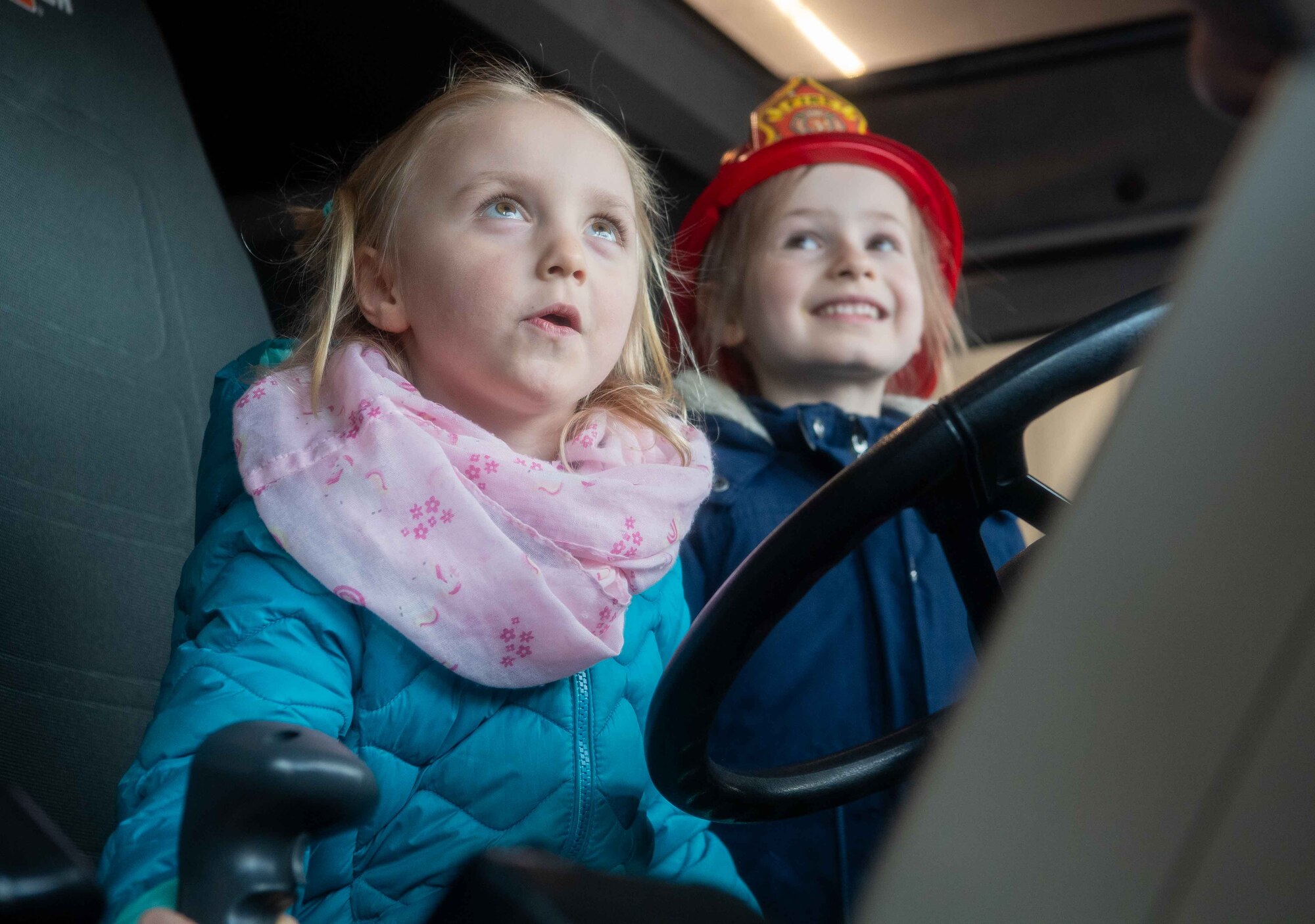 A Villa Winzig student sits in a fire truck during a base tour at Ramstein Air Base, Germany, April. 18, 2024. Children from Villa Winzig Kindergarten were given an opportunity to visit the base during the Host Nation community outreach program, which builds U.S. and German relations. (U.S. Air Force photo by Airman Dylan Myers)