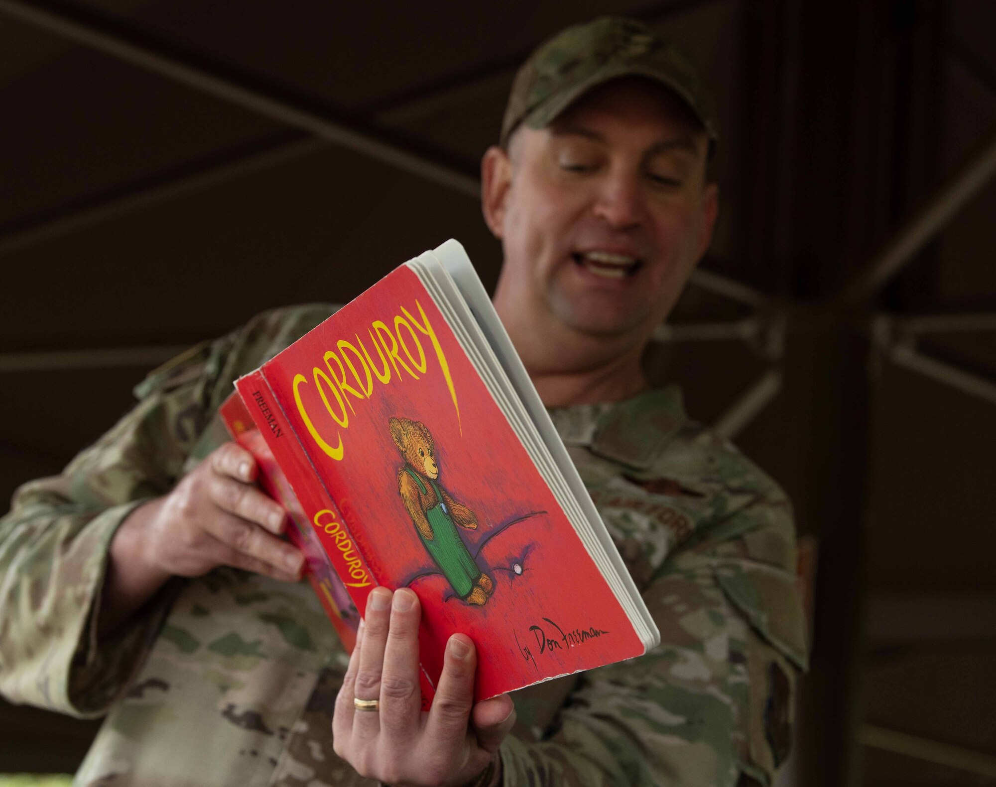 U.S. Air Force Chief MSgt. Louis Ludwig, 86th Airlift Wing command chief, reads a book in English to children during a Villa Winzig tour, Apr. 18, 2024. Community outreach programs like this one aim to foster stronger local bonds and introduce English to German children early through monthly volunteer sessions from the base. (U.S. Air Force photo by Airman Dylan Myers)
