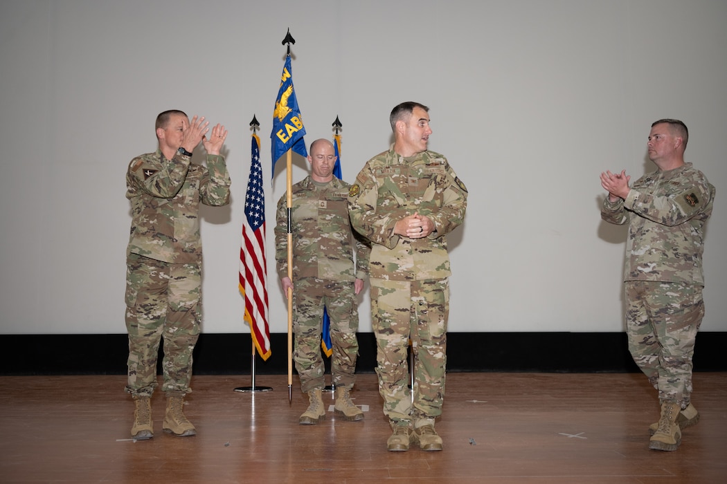 U.S. Air Force Brig. Gen. Douglas Jackson, 379th Air Expeditionary Wing commander, left, and Col. David Mays, former 6th Expeditionary Air Base Group commander, right, congratulate Col. Jeff Mrazik after he takes command of the 379th EABG at an undisclosed location within the U.S. Central Command area of responsibility, April 19th, 2024.